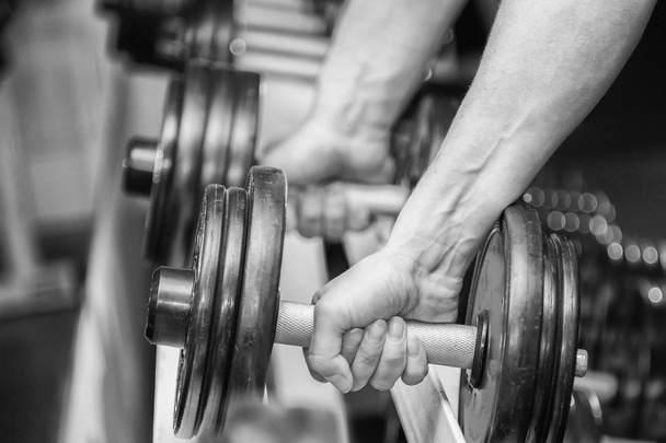 Hands holding dumbbell. - Photo, Image