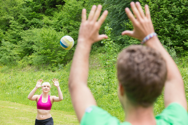 junges Paar spielt im Park Volleyball. - Foto, Bild