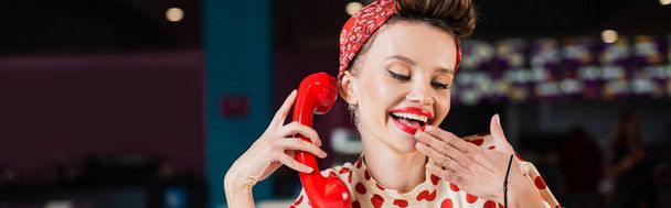 happy pin up woman holding retro handset in cafe, banner - Zdjęcie, obraz