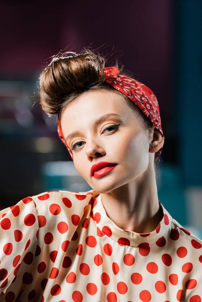 pretty pin up woman with red lips looking at camera  - Фото, зображення