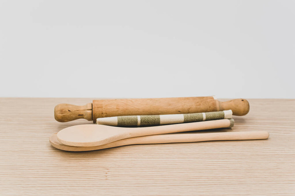 natural wood kitchen utensils and a table napkin on a wooden background with copy space - Foto, Imagem