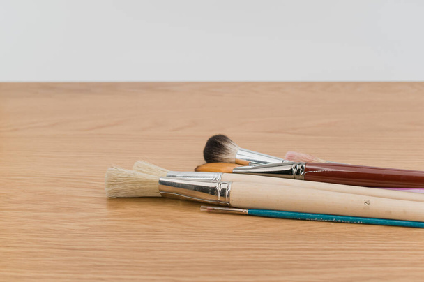 set of paintbrushes on a wooden tabletop with copy space - Photo, image