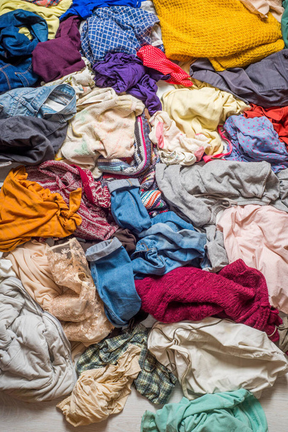 pile of used clothes on a light background. Second hand for recycling - Foto, afbeelding