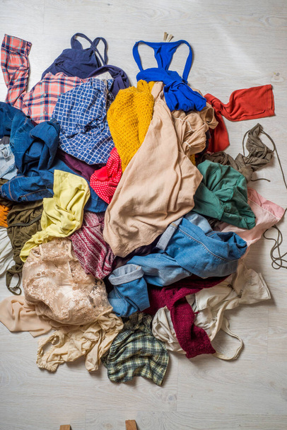 pile of used clothes on a light background. Second hand for recycling - Fotó, kép
