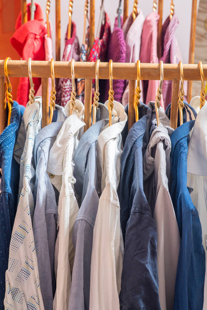 Rows of clothes on hangers. Place for text - Foto, imagen