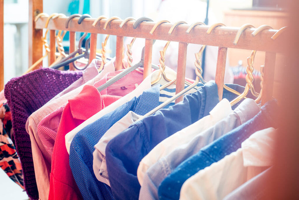 Lot of different clothes on hangers. Copy space - 写真・画像