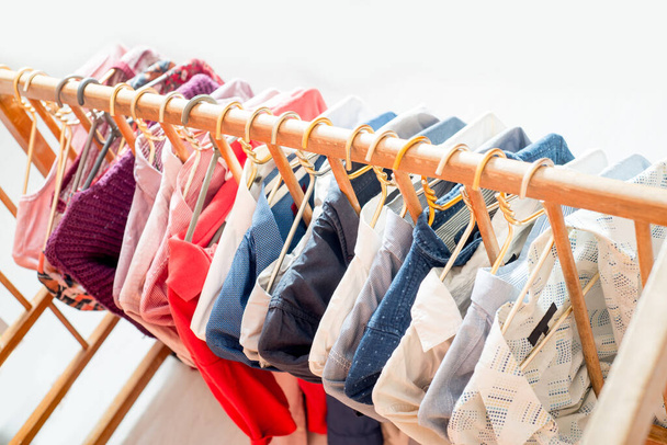 Clothes are hanging on hangers. Lots of clothes for sorting things in the wardrobe. - Fotoğraf, Görsel
