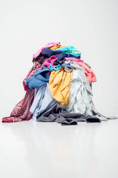 pile of used clothes on a light background. Second hand for recycling - Foto, Imagem