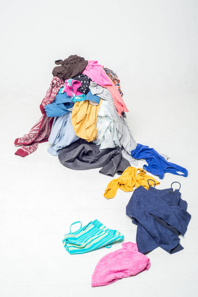 pile of used clothes on a light background. Second hand for recycling - Foto, Imagem