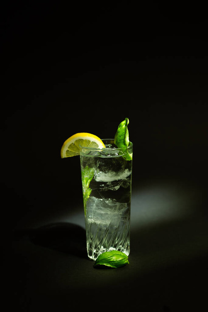 long drink glass with ice an clear liquid - Fotoğraf, Görsel