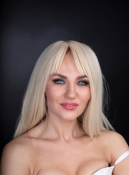 beautiful blonde woman posing in white lingerie - Fotoğraf, Görsel