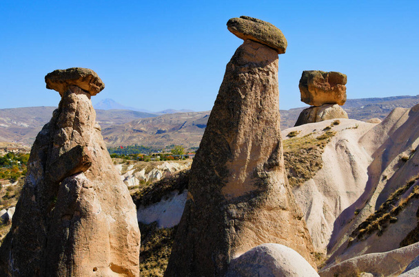Scenic landscape view of unusual rock formations. Three sisters (Uc Guzeller) rock. Amazing shaped sandstone rocks. Popular travel destination in Turkey. UNESCO World Heritage Site. - Fotografie, Obrázek