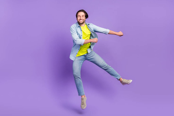 Full size photo of funky smiling male jumping dancing in air fooling around isolated on violet color background - Foto, imagen