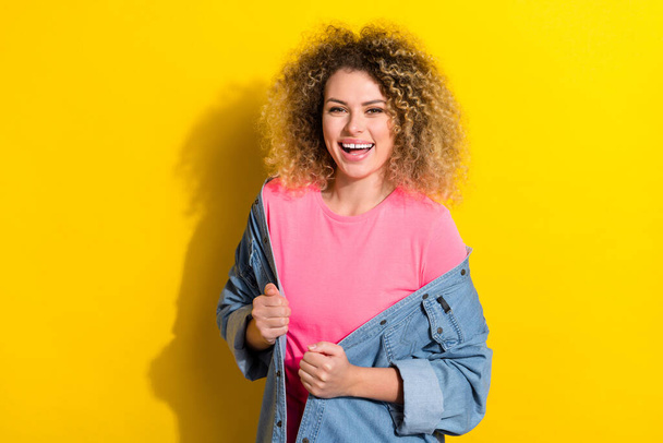Photo of funny carefree lovely cute lady enjoy comfy outfit wear jeans jacket isolated yellow color background - Photo, image