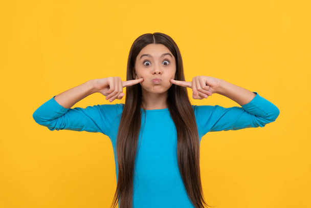 funny teen girl with long hair on yellow background, beauty - Photo, Image