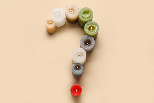 Question mark made of different burning candles on color background - Photo, Image