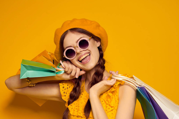 cheerful woman wearing sunglasses posing shopping fashion isolated background - Photo, image