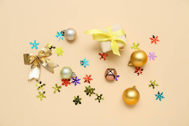Beautiful Christmas decorations, gift box and confetti on color background - Photo, Image
