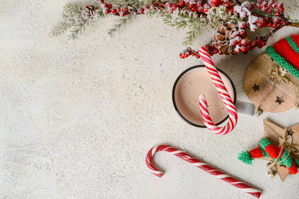 Cup of tasty cacao with candy canes on light background - Fotografie, Obrázek