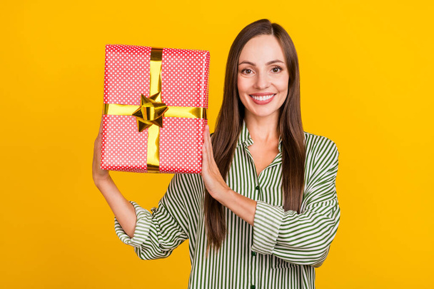 Photo of young cheerful pretty woman hold big present box event isolated over yellow color background - Fotó, kép