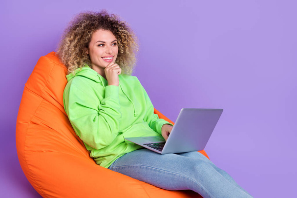 Photo of clever lady dressed green hoodie arm chin working gadget empty space isolated purple color background - Φωτογραφία, εικόνα