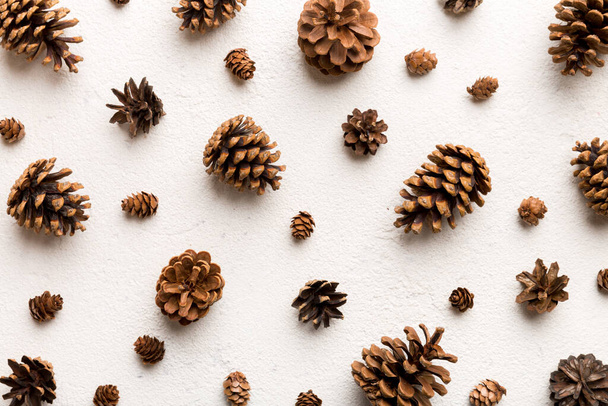 pine cones on colored table. natural holiday background with pinecones grouped together. Flat lay. Winter concept. - Φωτογραφία, εικόνα