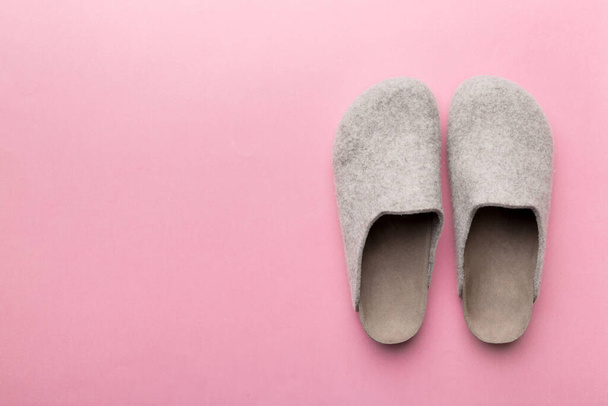 Warm winter women woolen slippers on colored background. Copy space for text. - Photo, Image