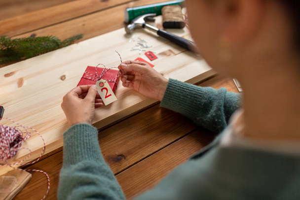 woman making advent calendar on christmas at home - Фото, изображение