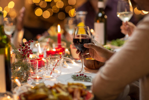 close up of man drinking wine at christmas party - Foto, Bild
