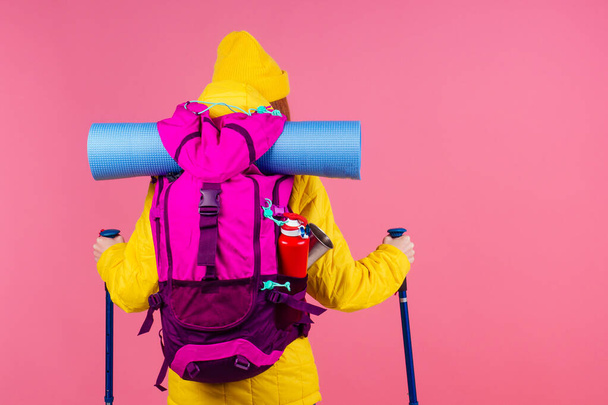 caucasian redhaired ginger woman with backpack and karemat in studio pink background. Ready for mountain adventure - Fotoğraf, Görsel