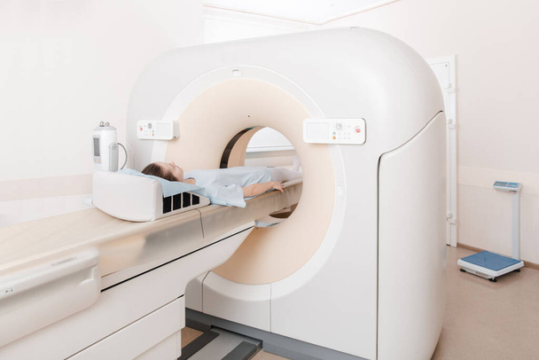 Medical CT or MRI Scan in the modern hospital laboratory. Interior of radiography department. Technologically advanced equipment in white room. Magnetic resonance diagnostics machine - Fotoğraf, Görsel