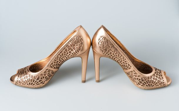 Woman gold shoes on background - Photo, Image