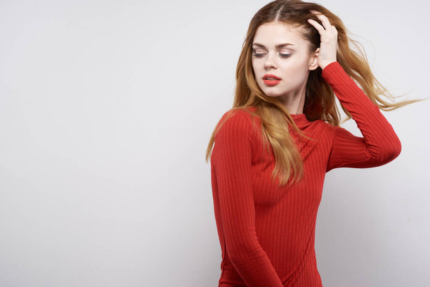 beautiful woman fashion hairstyle red sweater model light background - Fotó, kép