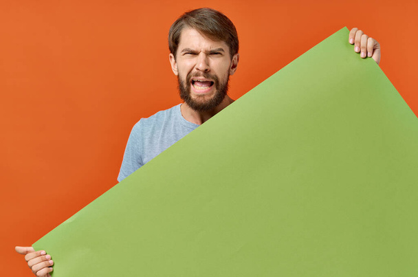 funny man holding a green banner design isolated background - Photo, Image