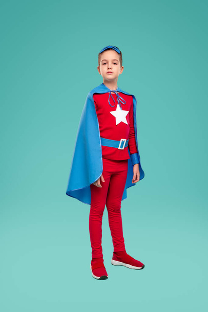 Confident superhero kid in superhero costume - Фото, изображение