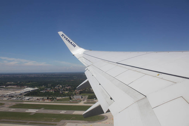 2021.06.06 Flughafen Mailand Malpensa, Billigfluggesellschaft Ryanair auf dem Flug nach Italien, Blick auf Landebahn und Tragfläche des Flugzeugs während des Starts  - Foto, Bild