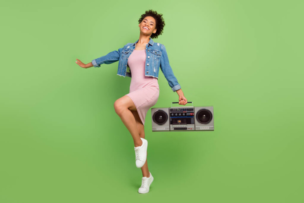 Full size photo of nice millennial lady with boom box wear dress shirt sneakers isolated on green background - 写真・画像
