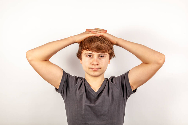 portrait of handsome boy with folded hands at head - Photo, Image
