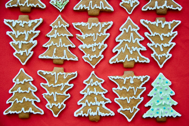 Christmas homemade gingerbread christmas tree cookies close up. One different. Handmade baking background. Festive card with aesthetic Christmas atmosphere. Merry Christmas and home coziness concept - Photo, Image