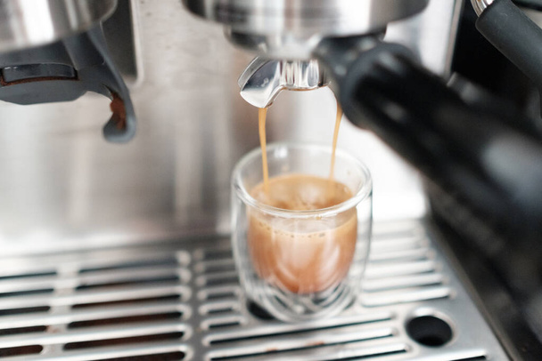 A beautiful shot of espresso coffee machine making a coffee with milk - Valokuva, kuva