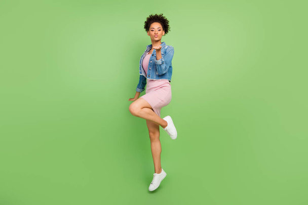 Full size profile photo of flirty millennial lady blow kiss wear dress shirt sneakers isolated on green background - Zdjęcie, obraz