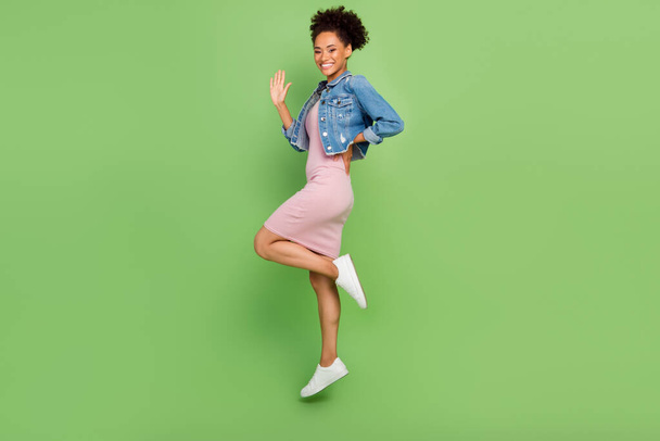 Full body profile photo of cool young lady jump wear dress shirt sneakers isolated on green background - Photo, Image