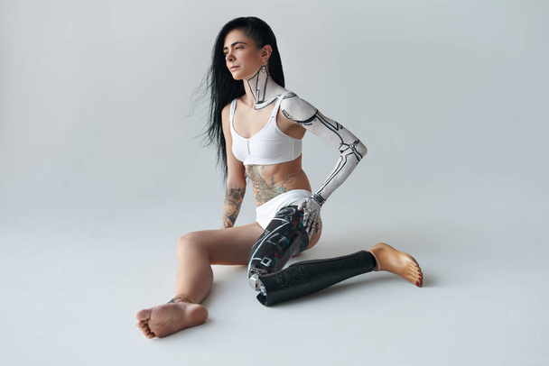 Futuristic creative avant-garde cyber body art at the girl with artificial leg - Fotó, kép