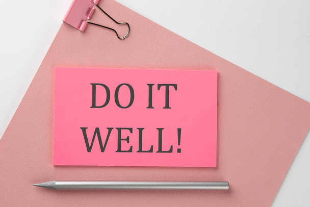 Pink sticker on pink paper with pencil on white background with text DO IT WELL - Foto, imagen