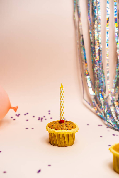 birthday concept, cupcake on pink background with candle - Photo, image