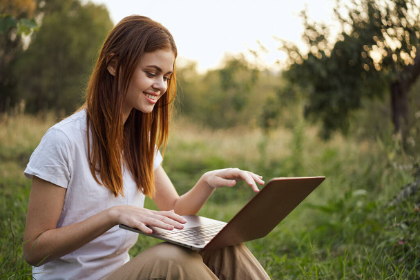 cheerful woman outdoors laptops communication internet recreation - Valokuva, kuva