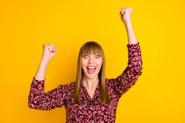 Photo portrait of blonde woman happy gesturing like winner isolated vivid yellow color background - Foto, afbeelding