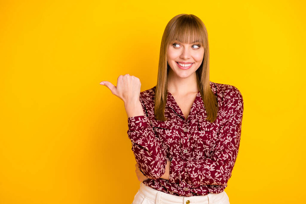 Photo portrait of curious business woman showing thumb copyspace advising isolated vibrant yellow color background - Photo, Image