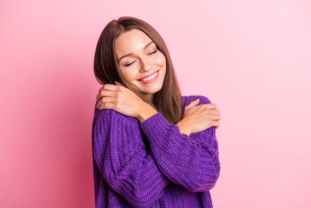 Photo of inspired adorable lady embrace shoulders wear purple sweater isolated pink color background - 写真・画像