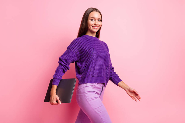 Profile portrait of adorable lady walking hold netbook look camera wear pullover isolated on pink color background - Фото, зображення